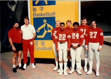The 1988 USA Goalball men's team poses outside the venue.