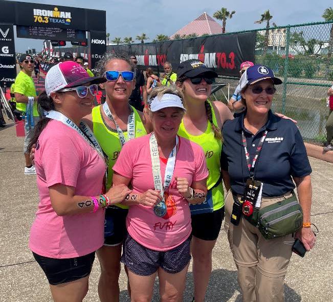 Sighted guide Cheyenne Meyer (second from right) poses with her all-blind female triathlon team that completed the 70.3 Ironman in Texas.