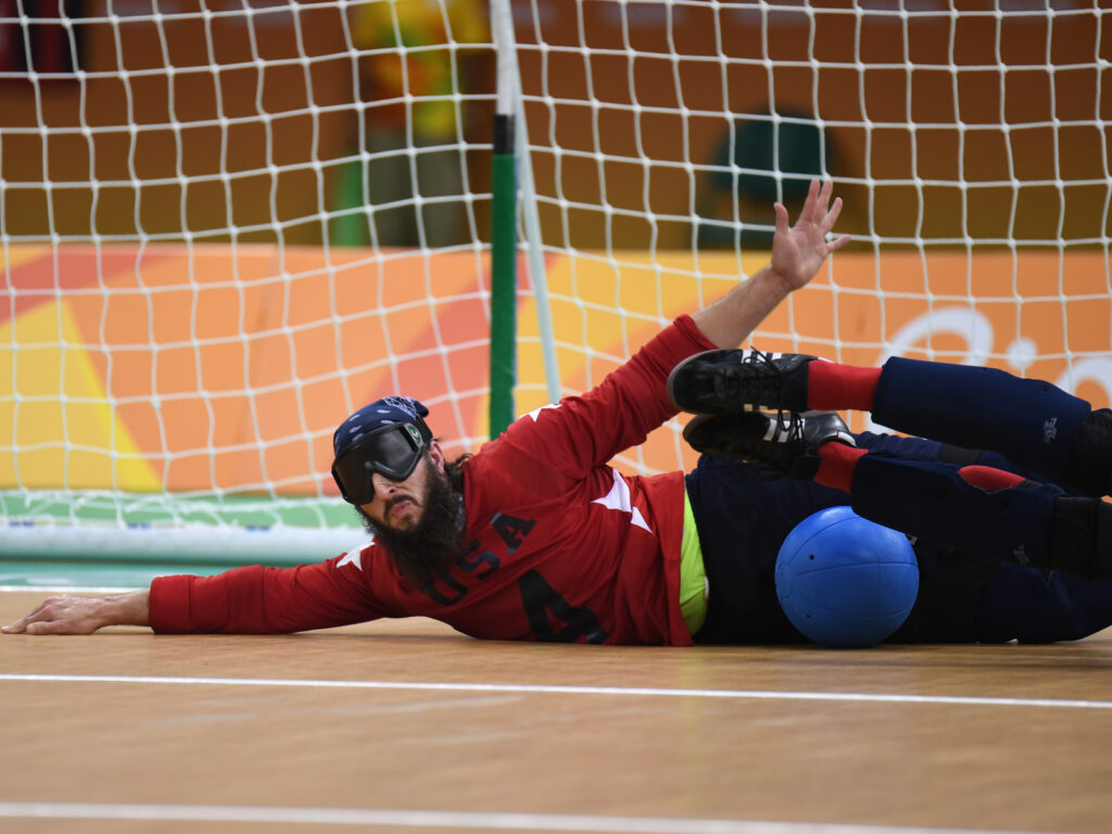 John Kusku blocks a ball with his body.