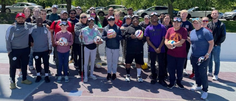 Participants in the Chicago Parks District blind soccer clinic pose with USABA Sport Ambassador Sheena Hager.